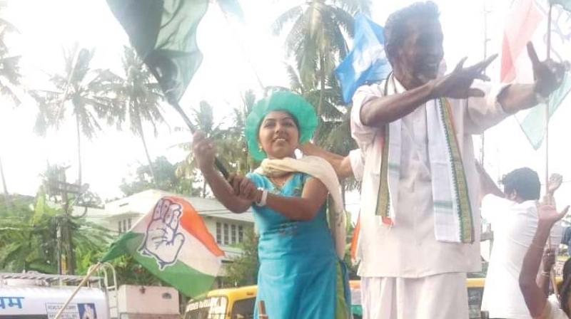 UDF workers celebrates even as winning Congress candidate K Seelas greets voters after winning  by-election to the Kinavoor ward on Friday.