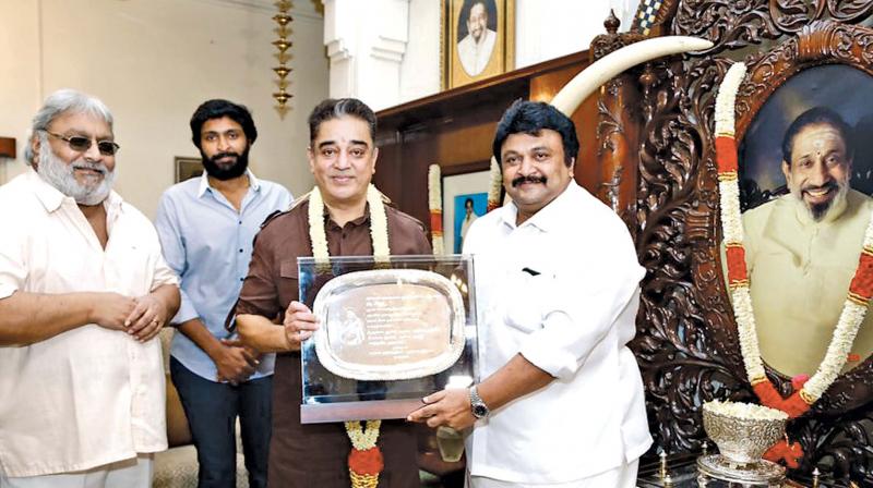 Kamal presented with a plaque