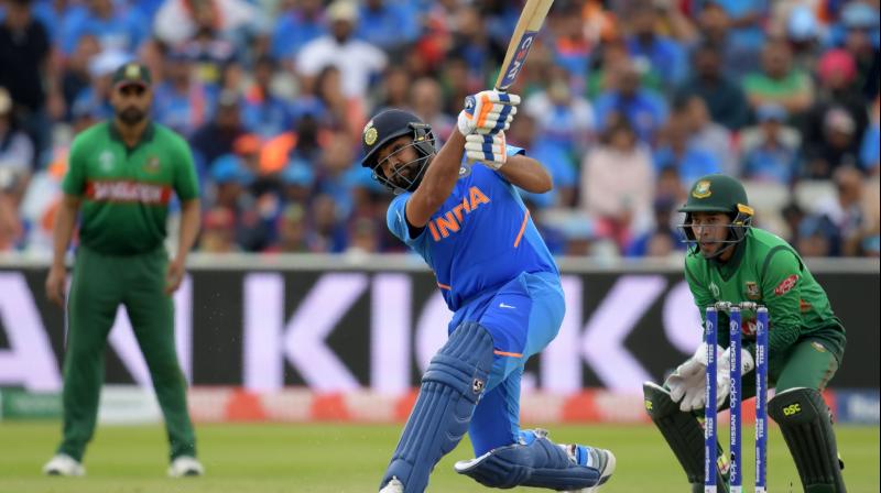 It was Rohits (104 off 92 balls) record-equalling fourth century in a single edition and his 180-run opening stand with K L Rahul (77 off 92 balls) that laid the foundation for a par-score of 314 for nine after India opted to bat. (Photo: AFP)