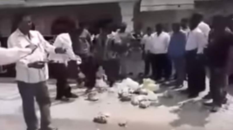 A video of GHMC food inspectors throwing stale food on the main road after they inspected Swagath Grand hotel, is going viral on social media.