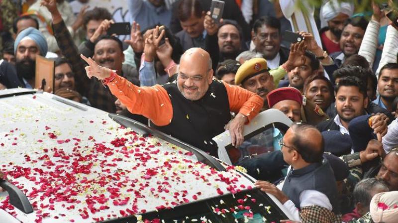BJP President Amit Shah gestures while being welcomed on his arrival at the party headquarters in New Delhi on Monday, after the partys victory in the Assembly elections in Gujarat and Himachal Pradesh. (Photo: PTI)