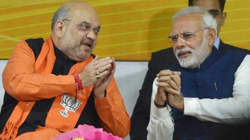 Prime Minister Narendra Modi and BJP President Amit Shah at a felicitation function before the partys parliamentary board meeting in New Delhi on Monday, after the partys win in Gujarat and Himachal Pradesh Assembly elections. (Photo: PTI)