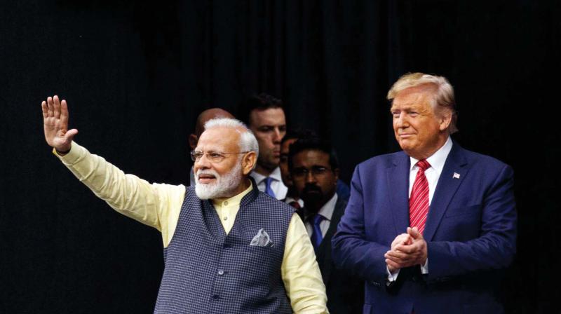 Prime Minister Narendra Modi and US President Donald Trump join hands at the Howdy, Modi! event at NRG Stadium in Houston, Texas, on Saturday. (Photo: AFP)