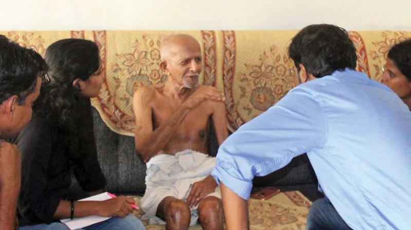 Researchers interviewing 88-year old Beeran Kutty, a native of  Elampulassery village as part of data collection