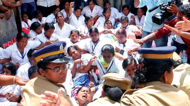 Police removes nurses affiliated to United Nurses Association who were protesting against Bharath Hospital for sacking nurses in Kottayam on Friday. 	(Photo: Rajeev Prasad)