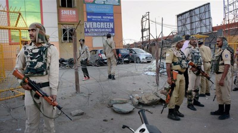 Security forces stand guard after a grenade attack by militants at Jehangir Chowk in Srinagar on Thursday. (Photo: PTI)