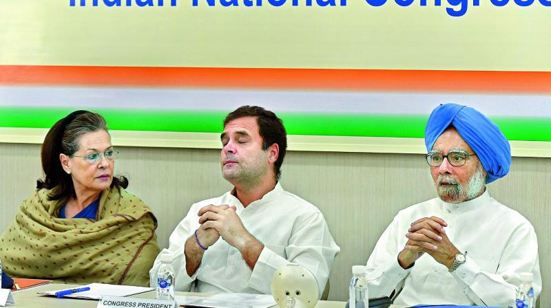 Congress President Rahul Gandhi with Sonia Gandhi and Manmohan Singh at the CWC meeting in New Delhi on Saturday. (Photo: AP)