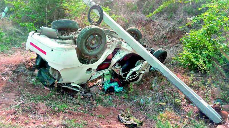 The car that hit electric poles by the roadside on Thursday midnight in Nagarkurnool district. Two people died in the mishap. (Photo:DC)