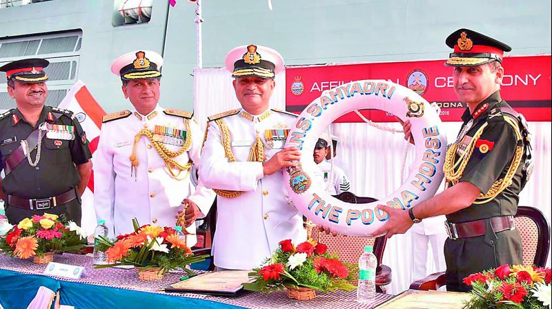 Commander-in-Chief of Eastern Naval Command Vice-Admiral H.C.S. Bisht and Colonel of the Poona Horse Regiment Lt Gen R.V. Kanitkar exchange mementos during an affiliation ceremony of INS Sahyadri in Visakhapatnam on Saturday. (Photo: DC)