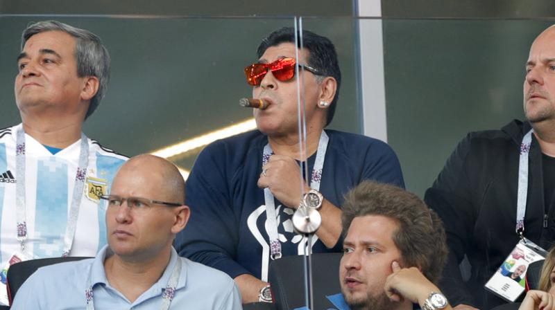Maradona was seen rounding off the ensemble for Argentinas tournament opener with a fat cigar as well. (Photo: AP)