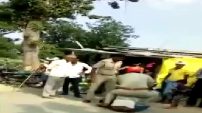 Watch: 2 UP cops drag, push, beat man in public as child looks on; suspended