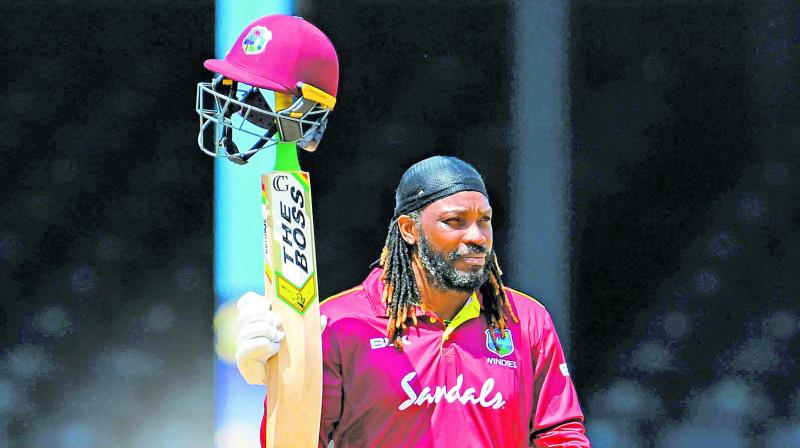 Chris Gayle  acknowledges the crowd as he walks back to the pavilion. (Photo: AFP)