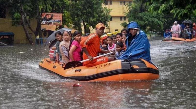 State Disaster Response Force (SDRF) workers rescue people from flood-affected area of Bahadurpur following heavy monsoon rainfall, in Patna. (Photo: PTI)