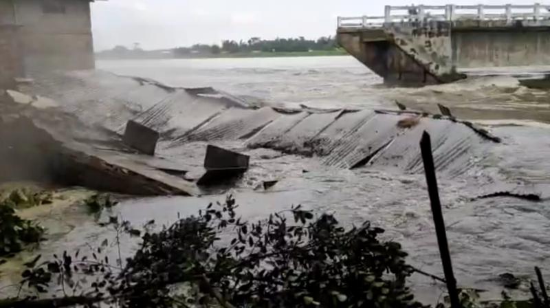 A TV grab shows a school getting washed away in gushing river waters in Assam on Friday.