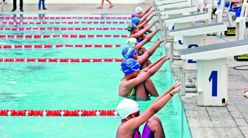 Girls prepare to make a splash at the start of the backstroke event at the inter-club swimming championship in Hyderabad.