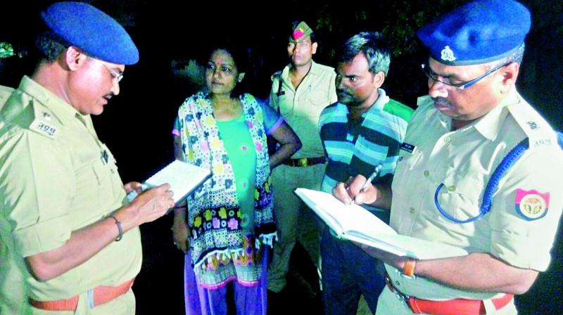 UP police speaking to the relatives of the woman who was attacked with acid, in Lucknow, on Sunday. (Photo: PTI)