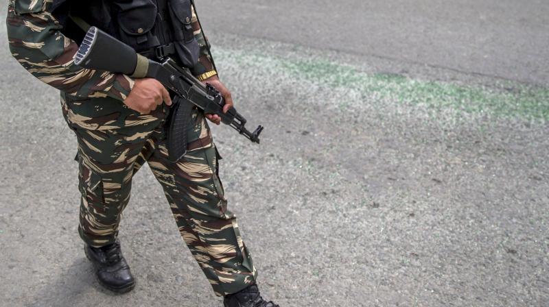 An Indian army soldier walks past shattered glasses of bus that was attacked in Batengoo about 50 Kilometres (31.25 miles) south Srinagar, Indian controlled Kashmir. (Photo: AP)