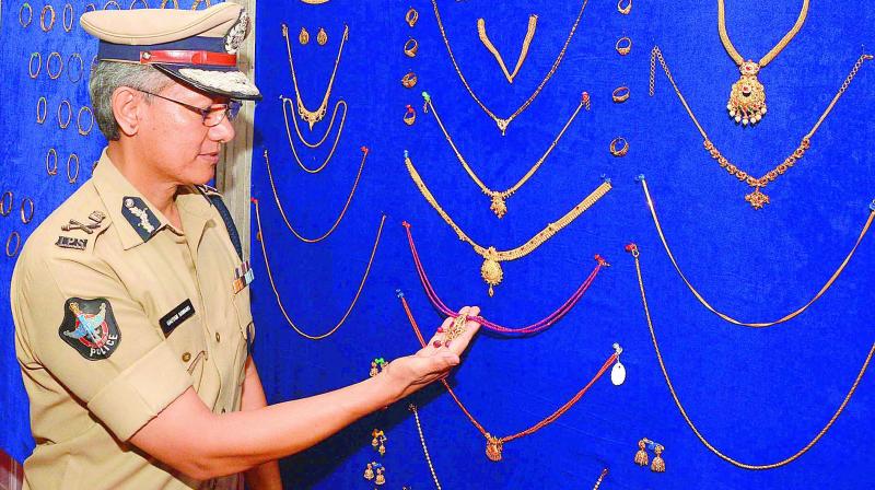 Commissioner of Police Gautam Sawang takes a look at the recovered gold ornaments in Vijayawada. (Photo: DC)