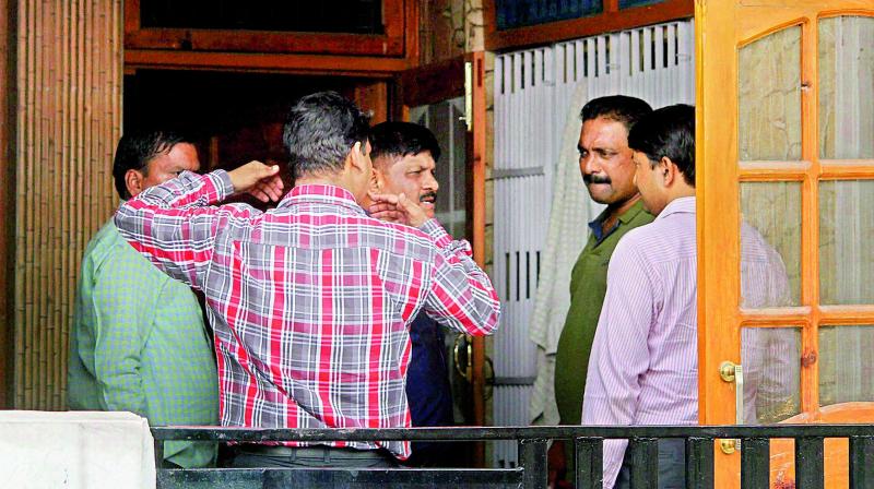 NIA officials during the raid on the residence of Devinder Singh Behal, an aide of separatist leader Syed Ali Shah Geelani, in Jammu on Sunday. (Photo: PTI)