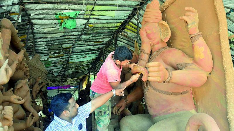 Artisans mould clay Ganesh idols at a makeshift workshop in Lawsons Bay in Visakhapatnam on Monday. (Photo: DC)