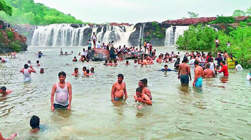 Tourists enjoy at the Bogatha waterfall at Cheekupalle village in Vajedu Mandal of Jayashankar Bhupalapalli district. With heavy rains lashing the village for the past three days, the district has become a sight to behold. (Photo: DC)