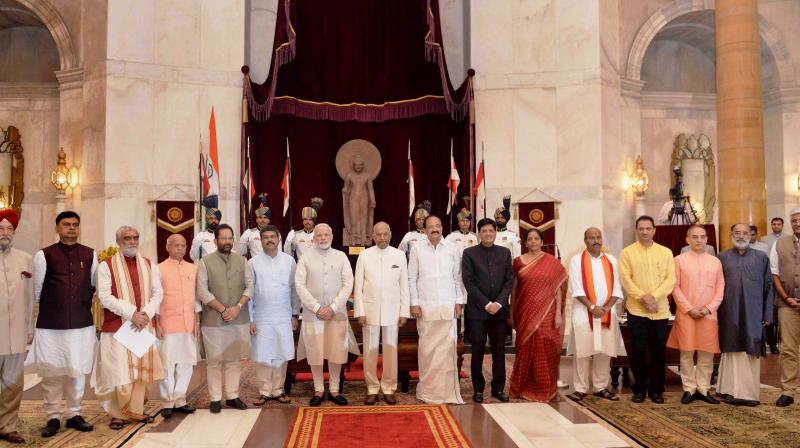 President Ram Nath Kovind, Vice President M. Venkaiah Naidu, Prime Minister Narendra Modi poses with new members of cabinet after the reshuffle at Rashtrapati Bhavan in New Delhi on Sunday. (Photo: PTI)