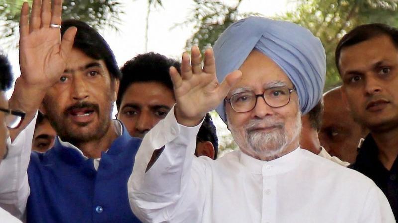 Former prime minister and senior Congress leader Monmohan Singh waves as he arrives for a meeting with party leaders, in Jammu on Sunday. (Photo: PTI)