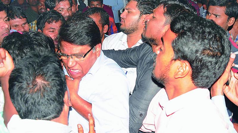 OU vice-chancellor S. Ramachandram being manhandled by students at the Maneru Hostel on the campus. (Photo: Deepak Deshpande)