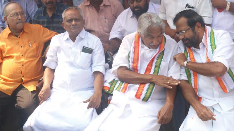 Former CM Oommen Chandy interacts with former Congress MLA Palode Ravi at the protest meeting organised by Save HLL Lifecare Forum in Thiruvananthapuram on Monday. Also seen is KPCC general secretary Thampanoor Ravi.  (Photo: G.G. Abhijith)