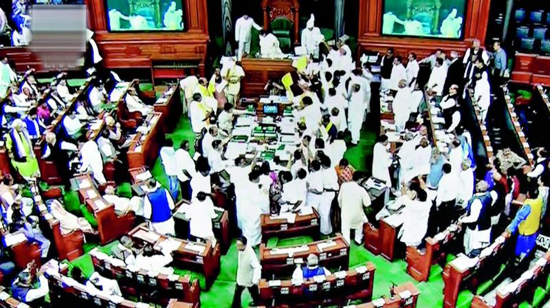 Opposition members protest during the ongoing Budget Session of Parliament at the Lok Sabha in New Delhi on Monday. (Photo: PTI)
