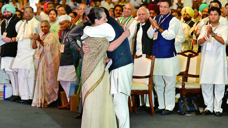 Congress President Rahul Gandhi hugs his mother chairperson CPP Sonia Gandhi after her speech at the 84th Plenary Session of Indian National Congress at the Indira Gandhi Stadium in New Delhi on Saturday. (Photo: PTI)