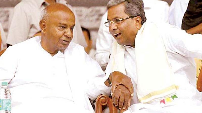 A file picture of JD(S) chief H.D. Deve Gowda with senior Congress leader Siddaramaiah.