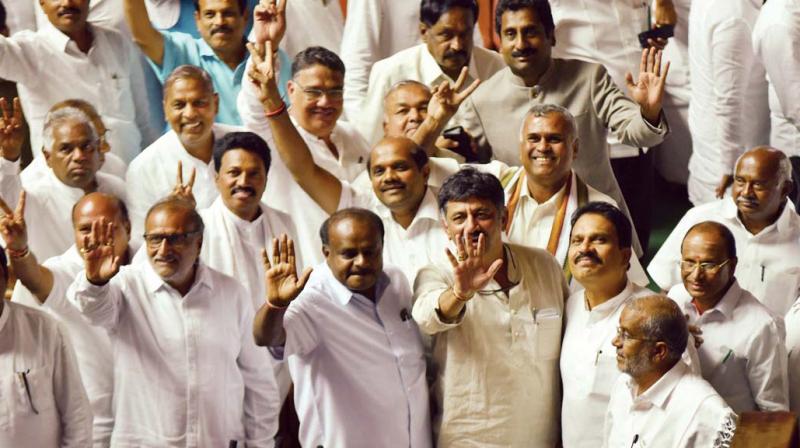 Members of the newly sworn-in JD(S) and Congress Legislators led by CM H.D. Kumaraswamy and Congress leader D.K. Shivakumar taking the trust vote with a show of hands, in Bengaluru on Friday. (Photo: DC)