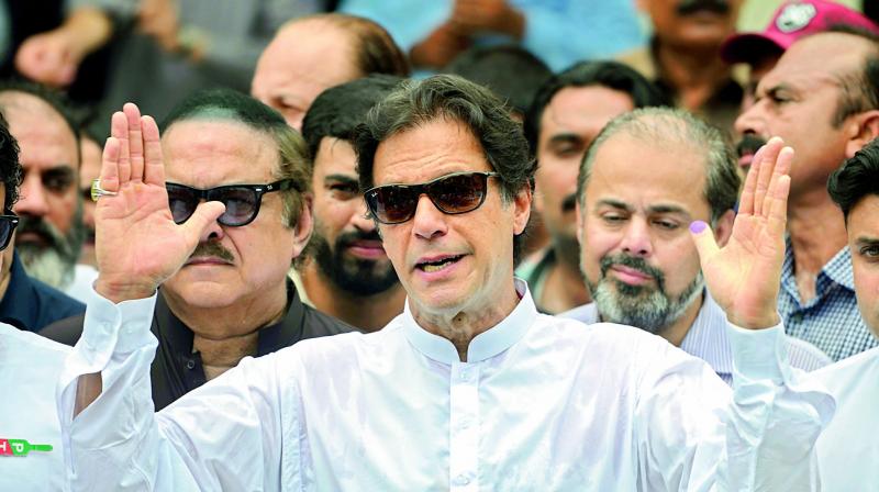 Pakistans cricketer-turned politician Imran Khan of the Pakistan Tehreek-e-Insaf (Movement for Justice) speaks to the media after casting his vote at a polling station during the general election in Islamabad. 	 File photograph
