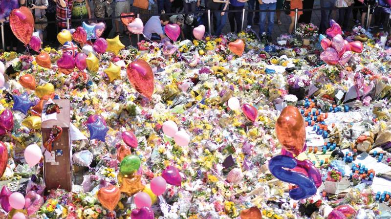 A carpet of messages of support and floral tributes to the victims of the Manchester attack lie in St Anns Square in Manchester on Saturday. 	( Photo: AFP)