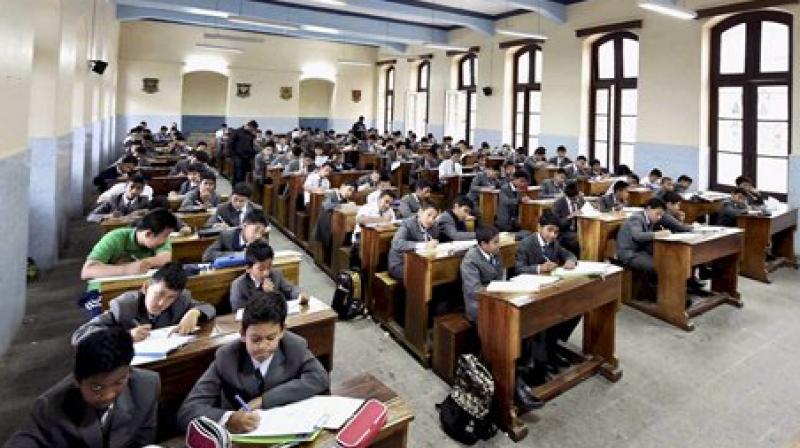 Students of St Josaph North Point school are busy their their examination during GJM called indefinite Bandh at Singhmari in Darjeeling. (Photo: PTI)