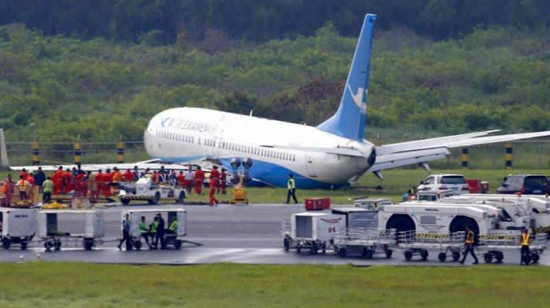 A Boeing passenger plane from China, a Xiamen Air, sits on the grassy portion of the runway of the Ninoy Aquino International Airport after it skidded off the runway while landing Friday, Aug. 17, 2018 in suburban Pasay city southeast of Manila, Philippines. (Photo: AP)