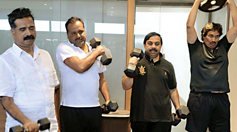 Ministers and legislators including Haratalu Halappa, U.T. Khader, Govindaraju and Kumar Bangarappa engage in physical exercises during the ongoing winter session of the state legislature in Belagavi on Friday