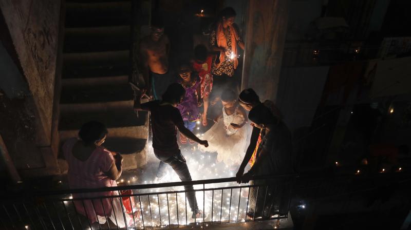 Poeple play with firecrackers during Diwali festival in New Delhi. (Photo: AP)
