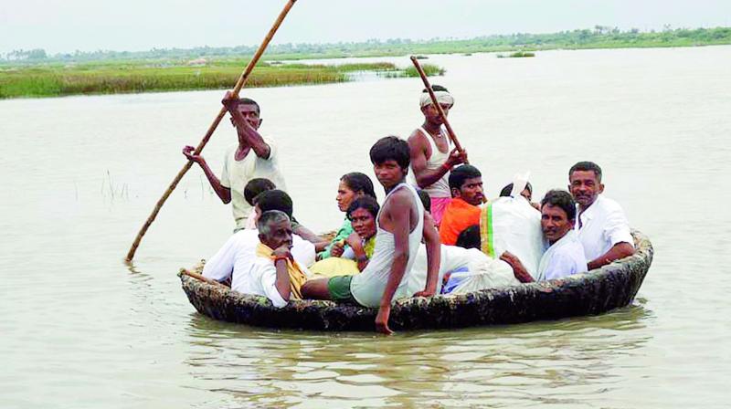 People travel in a teppa to cross River Krishna and reach Mahabubnagar district for Sigotham Jatara.