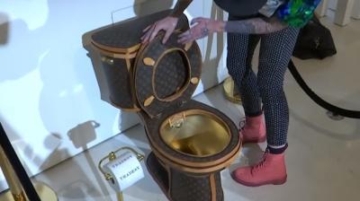 Golden toilet covered in Louis Vuitton bags put on sale for
