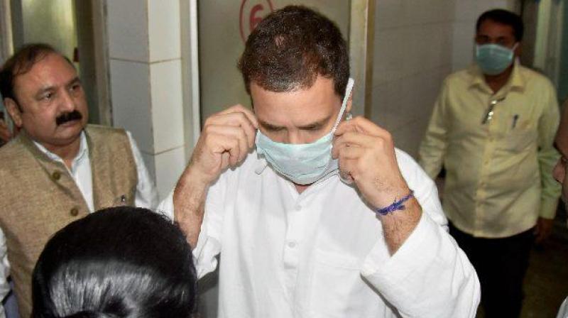 Congress vice-president Rahul Gandhi wears a mask to visit the injured victims of Unchahar NTPC boiler blast at the district hospital, in Raebareli on Thursday. (Photo: PTI)