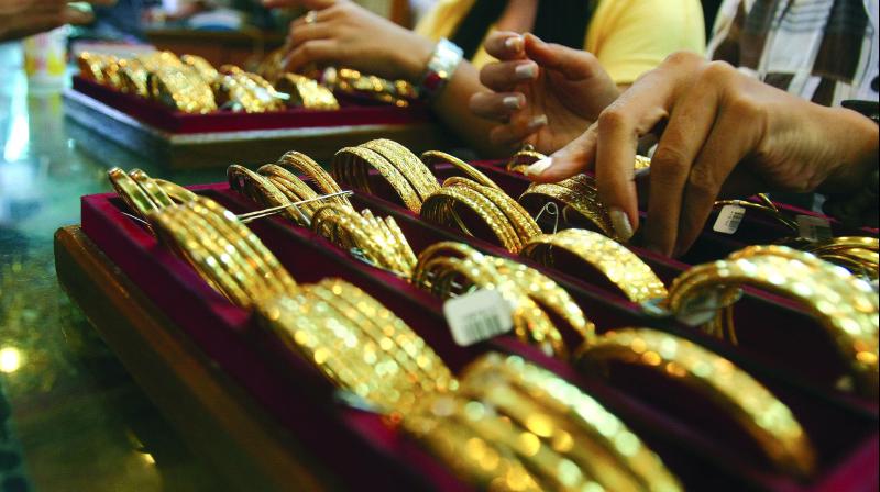 Gold slides Rs 70 on muted demand; silver jumps Rs 660