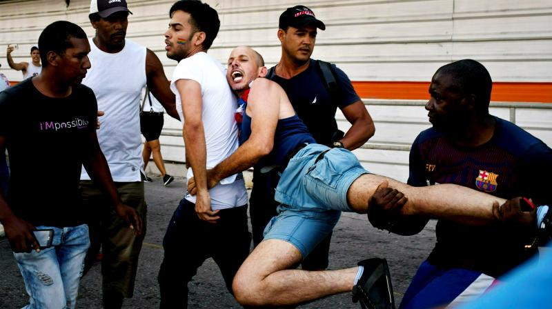Cuban police detain a gay rights activist taking part in an unauthorized march in Havana, Cuba. (Photo: AP)