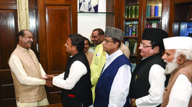 Samajwadi Party president Akhilesh Yadav, with party MPs, greets newly-elected Speaker for 17th Lok Sabha Om Birla as he takes charge at Parliament House in New Delhi on Wednesday (Photo: AP)