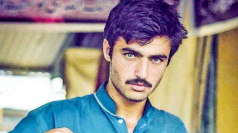 Arshad Khan candidly looks into the camera.
