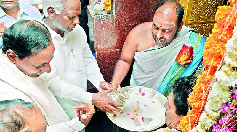 Chief Minister K. Chandrasekhar Rao offers a gold moustache  to Lord Veerabhadra Swamy at Kuravi in Mahbubabad district on Friday. (Photo: DC)