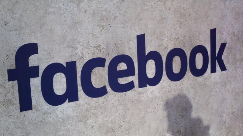 This file photo shows a Facebook logo being displayed in a start-up companies gathering at Paris Station F, in Paris. Facebook is taking baby steps for now to address the latest privacy scandal after news broke Friday, March 16, 2018, that Cambridge Analytica may have used data improperly obtained from roughly 50 million Facebook users to try to sway elections. (AP Photo/Thibault Camus, File)