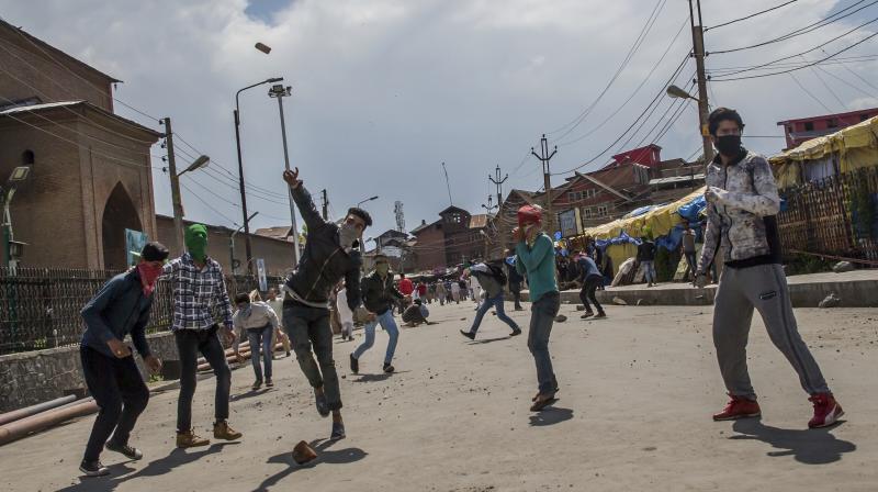 Clashes broke out between protestors and security forces after 3 militants were killed in Pulwama, Kashmir. (Photo: AP)