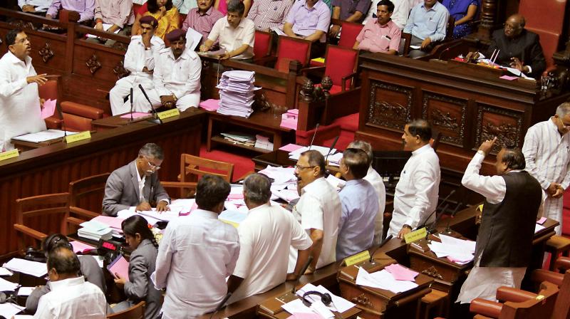 Former Home Minister Dr G Parameshwar argues with the protesting BJP MLCs during the Council session in Bengaluru on Friday 	(Photo:DC)